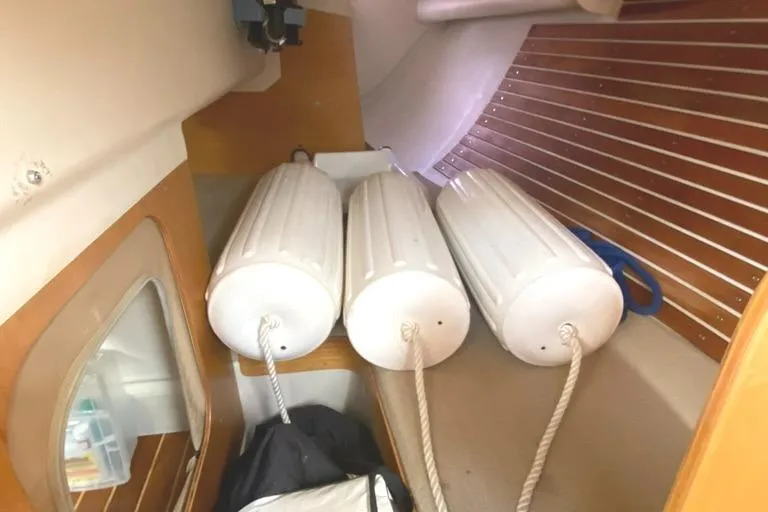 Slide: The Image of Interior of 1986 Express 37 sailboat with three white fenders and wooden paneling. - 26