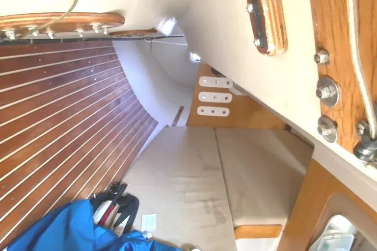 Slide: The Image of Interior of 1986 Express 37 sailboat with wooden paneling and seating area. - 27
