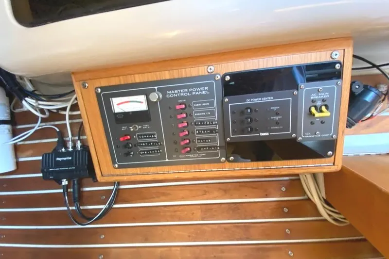 Slide: The Image of Electrical control panel on a 1986 Express 37 boat, featuring switches and gauges. - 29
