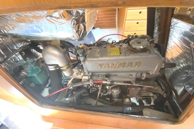 Slide: The Image of Yanmar engine inside 1986 Express 37 sailboat, surrounded by reflective insulation. - 33