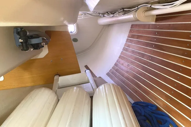 Slide: The Image of Interior of a 1986 Express 37 sailboat with wooden flooring and nautical equipment. - 42