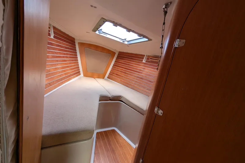 Slide: The Image of Cozy cabin interior of 1986 Express 37 sailboat with wooden paneling and skylight. - 47