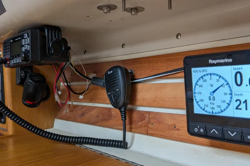 Slide: The Image of Boat navigation equipment on Express 37, 1986 model, featuring radio and Raymarine display. - 51