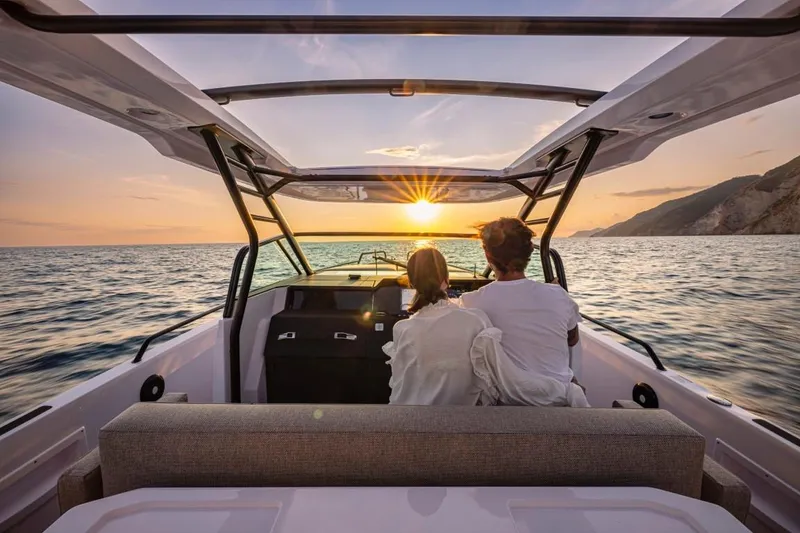 Slide: The Image of Couple enjoying sunset on 2025 Axopar 37 Sun Top boat, ocean view. - 10
