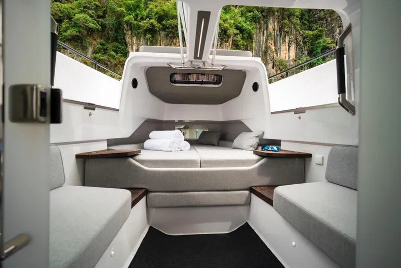 Slide: The Image of Interior of 2025 Axopar 37 Sun Top boat, featuring modern seating and cozy cabin design. - 7