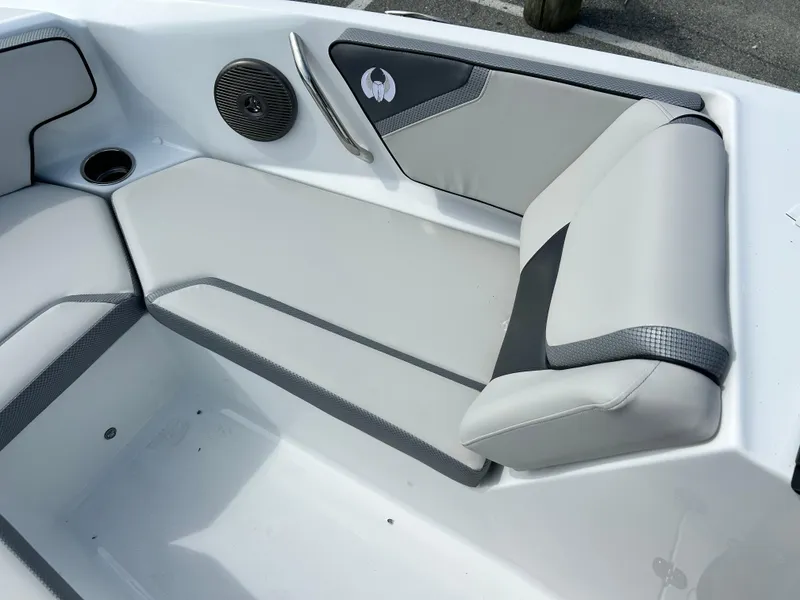 Slide: The Image of 2025 Scarab 195 SE boat interior with gray seating and speaker. - 10