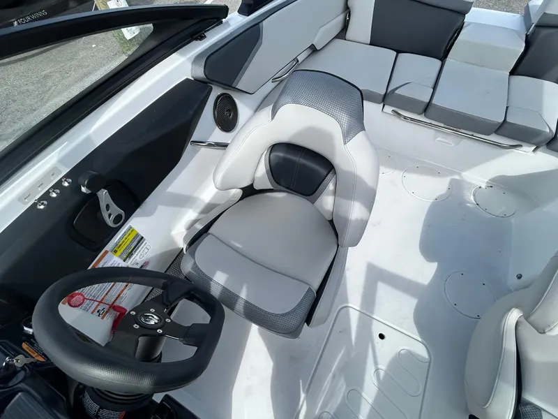 Slide: The Image of 2025 Scarab 195 SE boat interior with modern seating and steering wheel. - 13