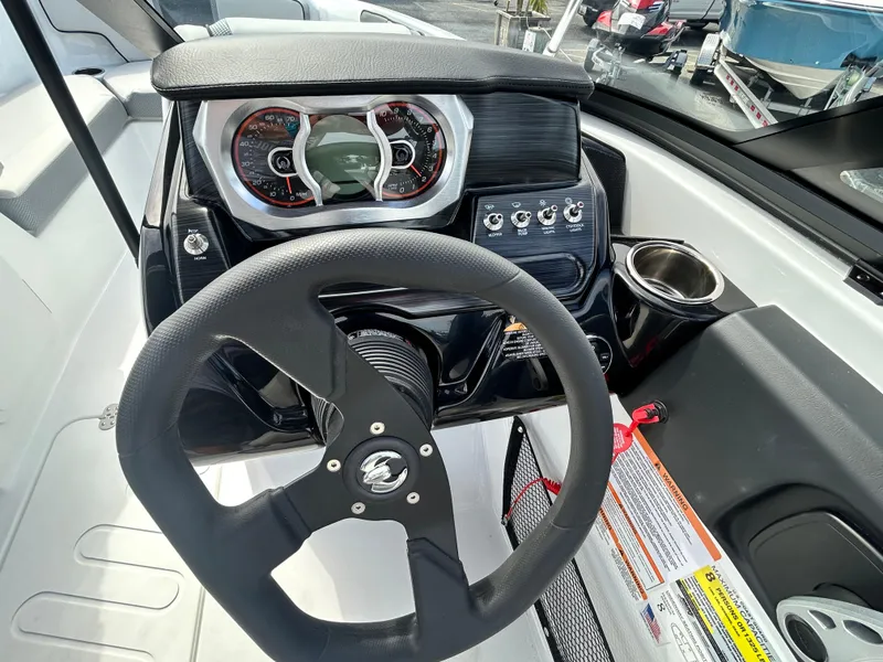Slide: The Image of Steering wheel and dashboard of 2025 Scarab 195 SE boat, featuring modern controls and gauges. - 16