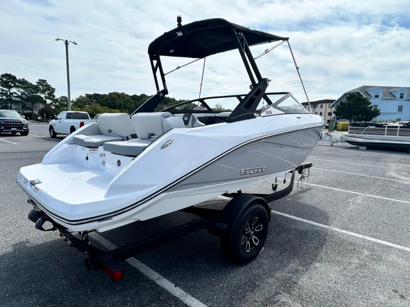 Slide: The Image of 2025 Scarab 195 SE boat on trailer in parking lot, featuring sleek white design. - 4