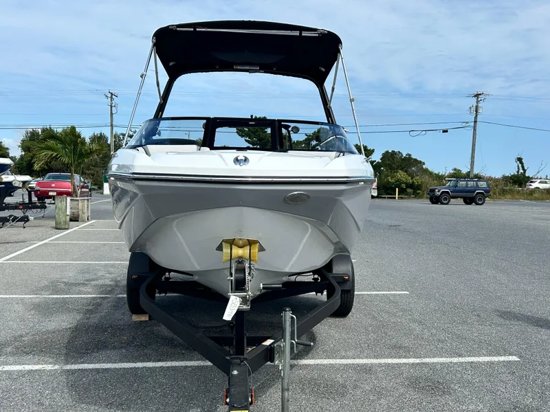 Slide: The Image of 2025 Scarab 195 SE boat on trailer in parking lot, front view. - 6
