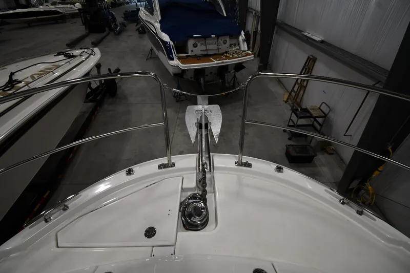 Slide: The Image of 2023 Jeanneau NC1095 boat bow with anchor in a storage facility. - 12