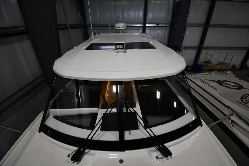 Slide: The Image of 2023 Jeanneau NC1095 boat in a warehouse, showcasing sleek design and modern features. - 17