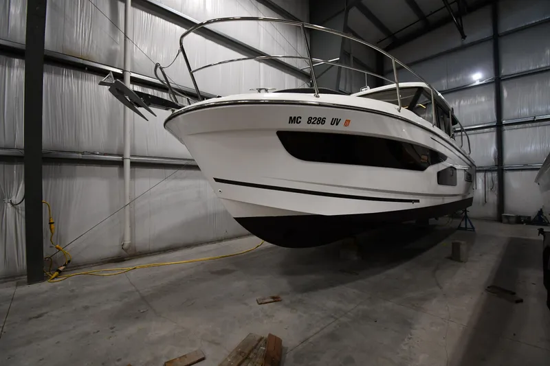Slide: The Image of 2023 Jeanneau NC1095 boat in indoor storage facility. - 2