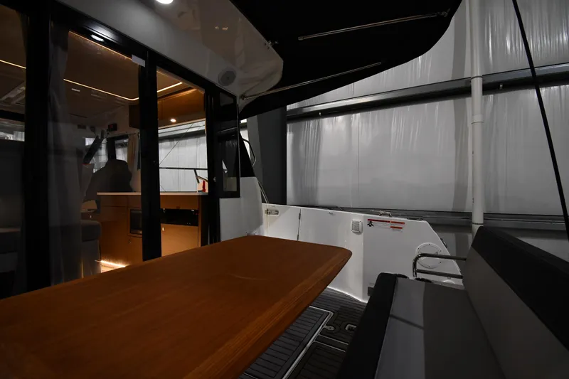 Slide: The Image of Interior view of 2023 Jeanneau NC1095 boat, featuring a sleek dining area and modern design. - 20