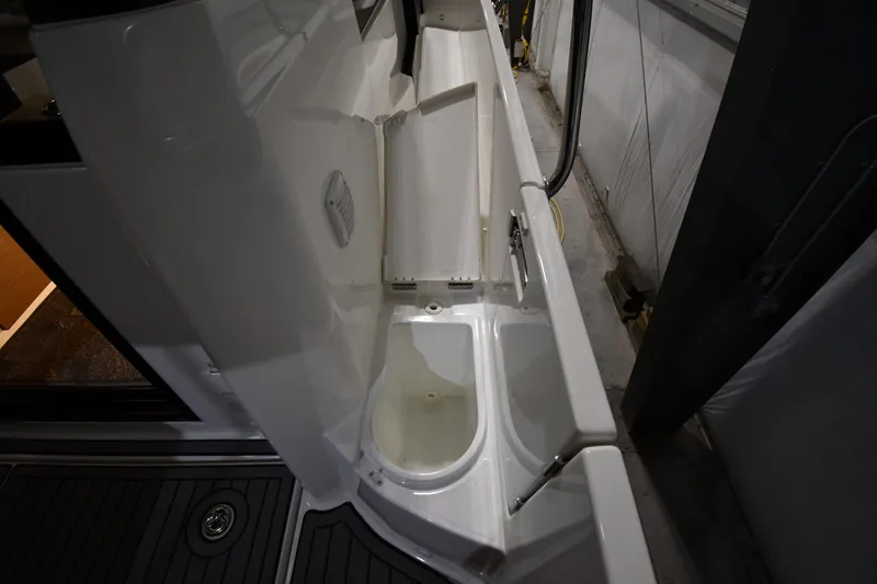 Slide: The Image of 2023 Jeanneau NC1095 boat deck with storage compartment and sleek design. - 27