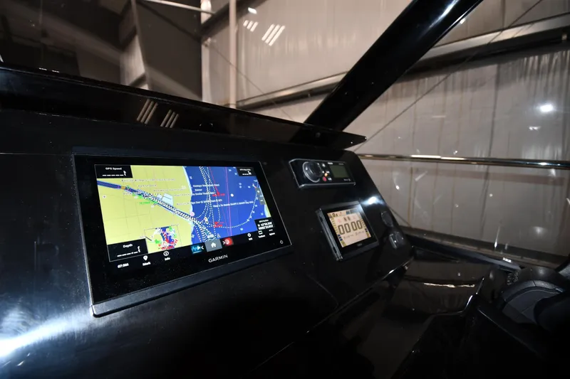 Slide: The Image of 2023 Jeanneau NC1095 helm with Garmin navigation display and controls. - 31