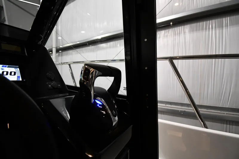 Slide: The Image of 2023 Jeanneau NC1095 boat cockpit with modern controls and sleek design. - 32