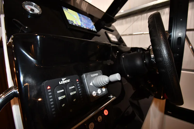 Slide: The Image of 2023 Jeanneau NC1095 helm with steering wheel, controls, and navigation display. - 33
