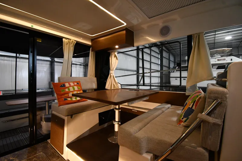 Slide: The Image of Interior of 2023 Jeanneau NC1095 boat with cozy seating and colorful cushions. - 40