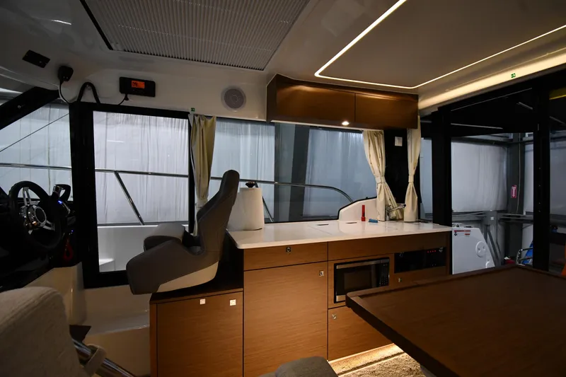 Slide: The Image of Interior of 2023 Jeanneau NC1095 boat with modern kitchen and helm station. - 42
