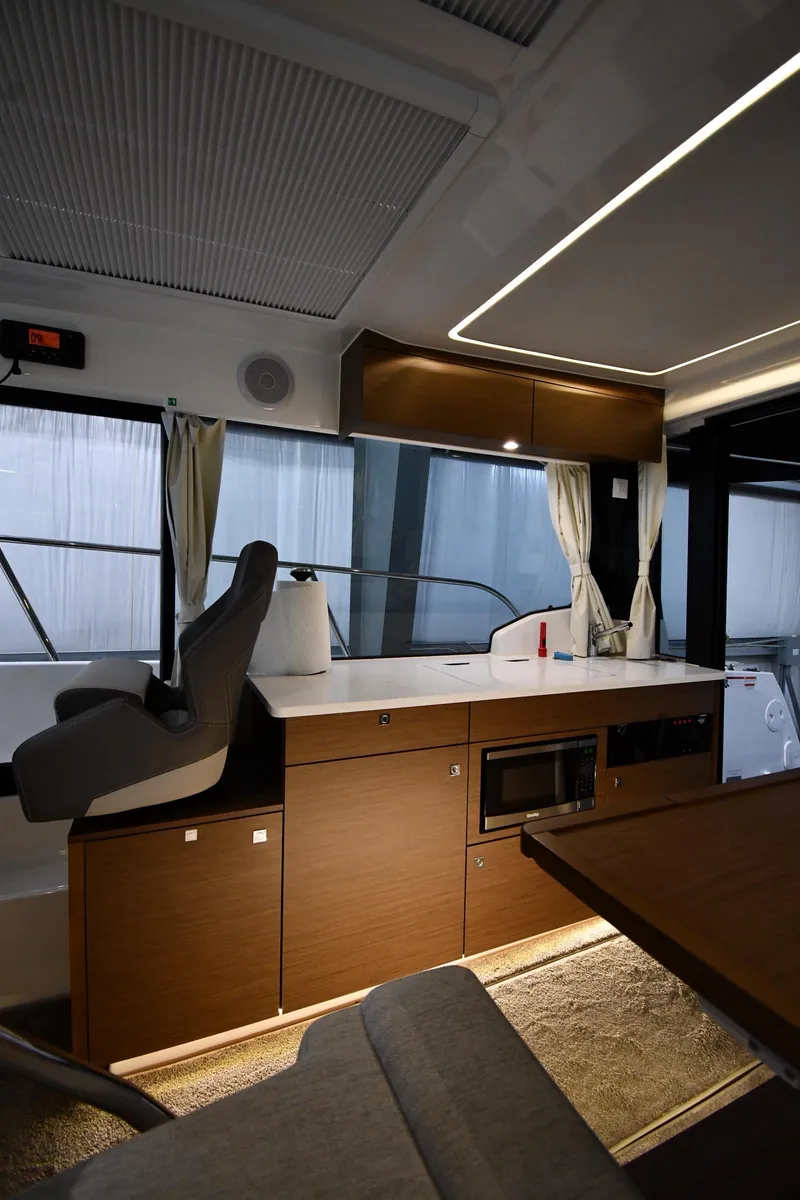 Slide: The Image of 2023 Jeanneau NC1095 interior with modern kitchen and seating area. - 43