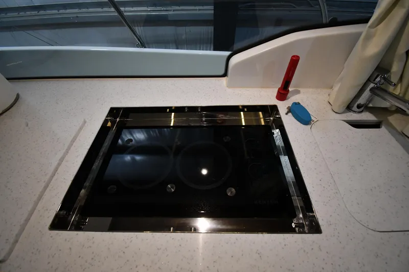 Slide: The Image of Modern kitchen area on 2023 Jeanneau NC1095 boat with sleek cooktop and accessories. - 44