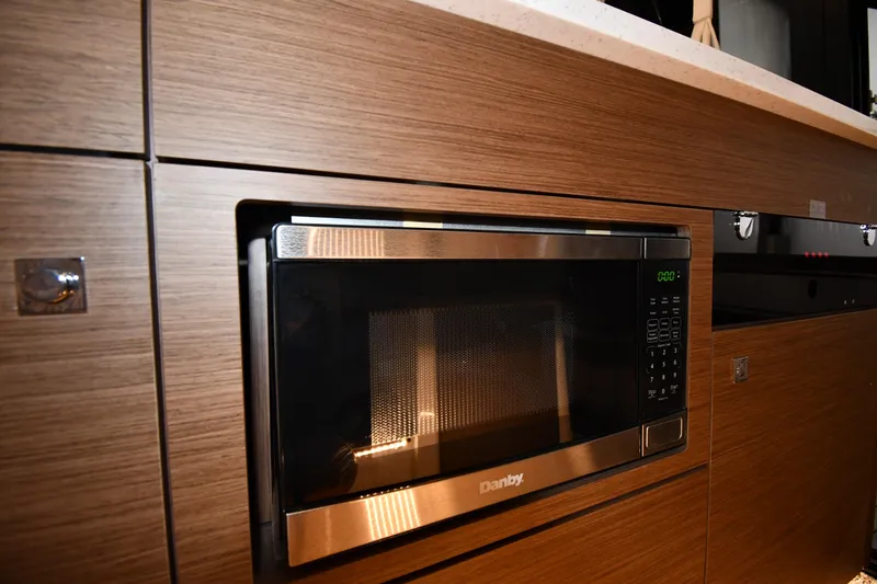 Slide: The Image of Modern kitchen with built-in Danby microwave on Jeanneau NC1095, 2023 model. - 46