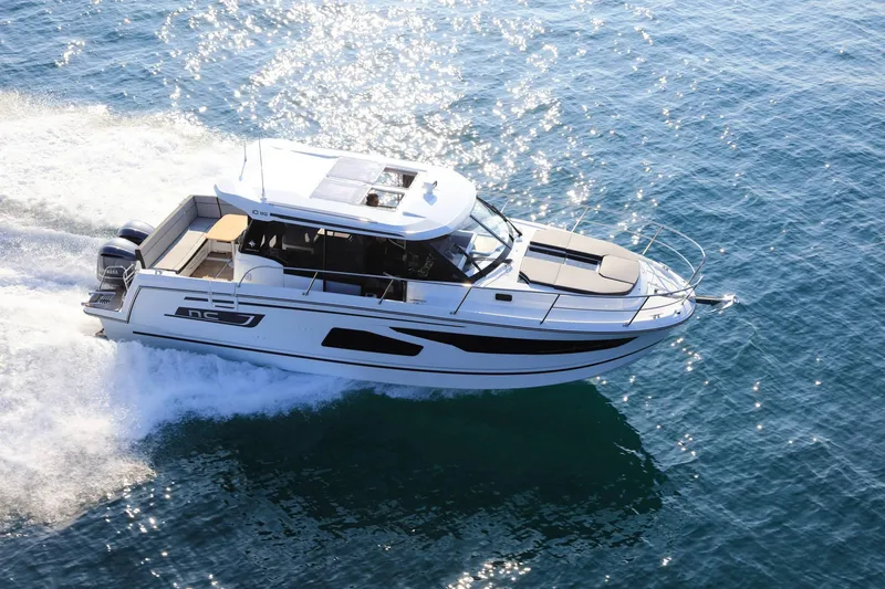 Slide: The Image of 2023 Jeanneau NC1095 cruising on open water, showcasing sleek design and performance. - 6