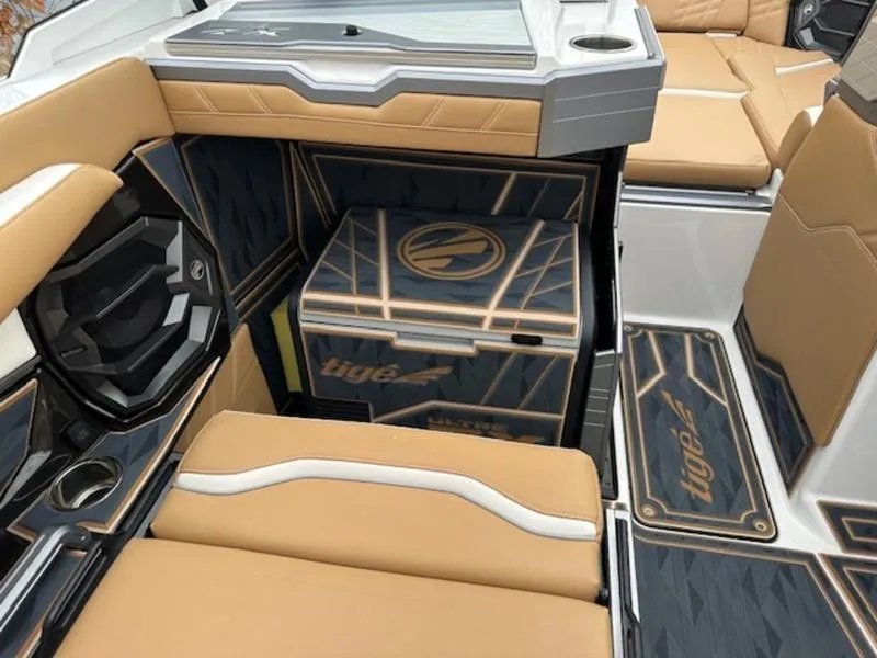 Slide: The Image of 2025 Tigé Ultré 25ZX boat interior with tan and black seating, stylish design. - 10