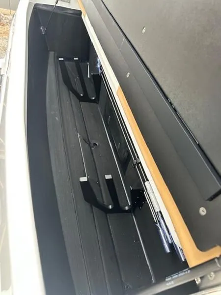 Slide: The Image of 2025 Tigé Ultré 25ZX boat storage compartment with sleek design and ample space. - 13