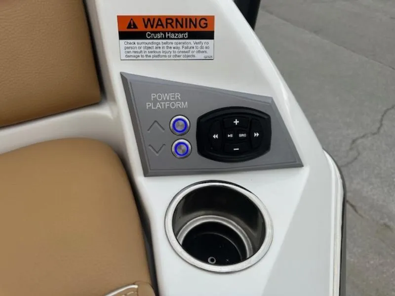 Slide: The Image of Control panel and cup holder on 2025 Tigé Ultré 25ZX boat, featuring power platform buttons. - 14