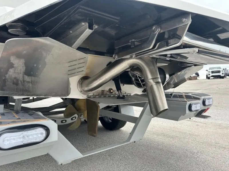 Slide: The Image of 2025 Tigé Ultré 25ZX boat underside showing propeller and exhaust system. - 2