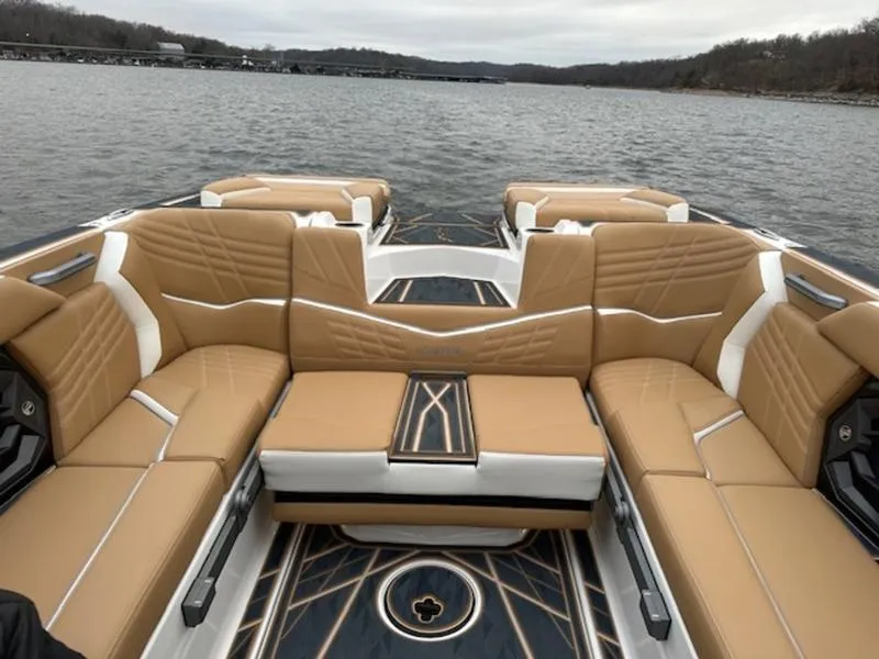 Slide: The Image of 2025 Tigé Ultré 25ZX boat interior with tan seating on a lake. - 5