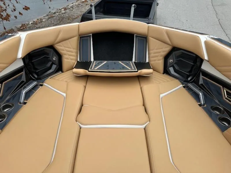 Slide: The Image of 2025 Tigé Ultré 25ZX boat interior with tan upholstery and sleek design. - 9