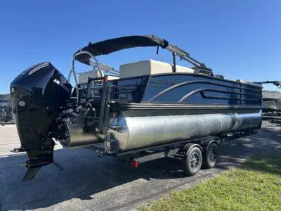 Slide: The Image of 2025 Lowe SS 250 Walk Thru pontoon boat on trailer, featuring sleek design and powerful motor. - 3