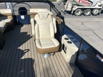 Slide: The Image of 2025 Lowe SS 250 WALK THRU boat interior with beige seating and cup holders. - 6