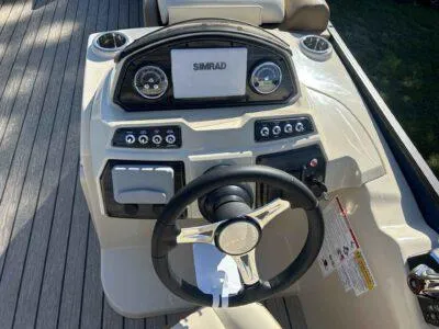 Slide: The Image of 2025 Lowe SS 250 WALK THRU boat dashboard with Simrad display and controls. - 7