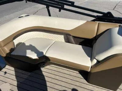 Slide: The Image of 2025 Lowe SS 250 WALK THRU boat interior with beige and brown seating. - 9