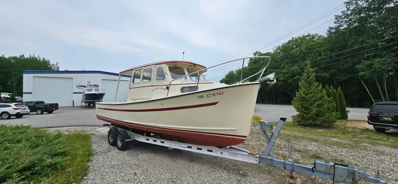 The Image of 2001 Rosborough RF-246 Custom Wheelhouse boat on trailer, parked near a building. - 0