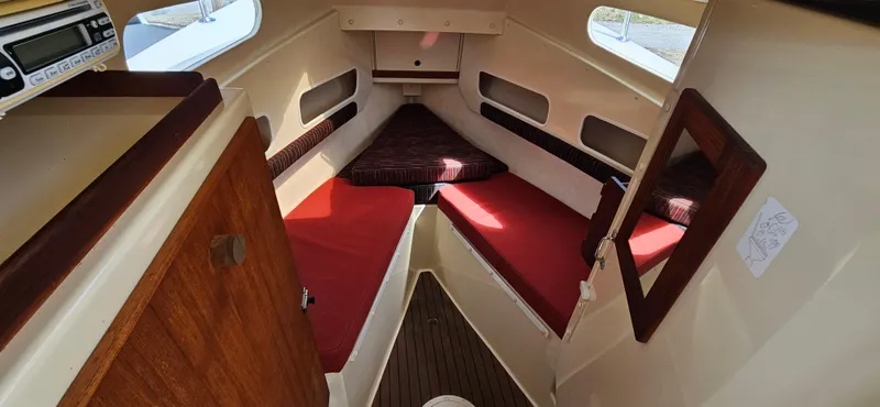 Slide: The Image of 2001 Rosborough RF-246 Custom Wheelhouse interior with red cushions and wooden accents. - 14