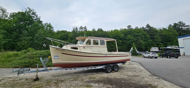 Slide: The Image of 2001 Rosborough RF-246 Custom Wheelhouse boat on trailer, parked outdoors near trees. - 21