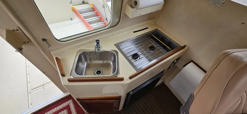 Slide: The Image of 2001 Rosborough RF-246 Custom Wheelhouse interior with sink, stove, and compact kitchen area. - 23