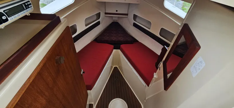 Slide: The Image of 2001 Rosborough RF-246 Custom Wheelhouse interior with red cushions and wood accents. - 26