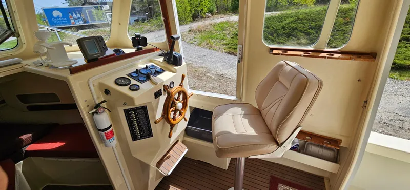 Slide: The Image of 2001 Rosborough RF-246 Custom Wheelhouse interior with steering wheel and control panel. - 9