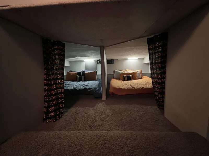 Slide: The Image of Cozy interior of a 1996 Skipperliner 61x16 houseboat with two beds and decorative curtains. - 10