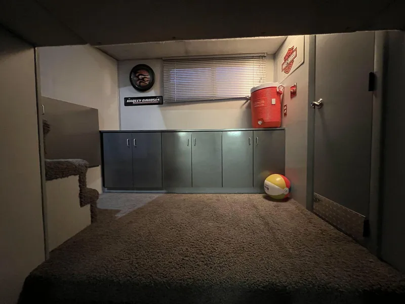 Slide: The Image of Interior of a 1996 Skipperliner 61x16 Houseboat with carpeted floor and storage cabinets. - 11