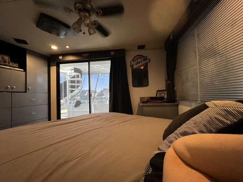 Slide: The Image of Cozy bedroom interior of a 1996 Skipperliner 61x16 houseboat with modern decor. - 13