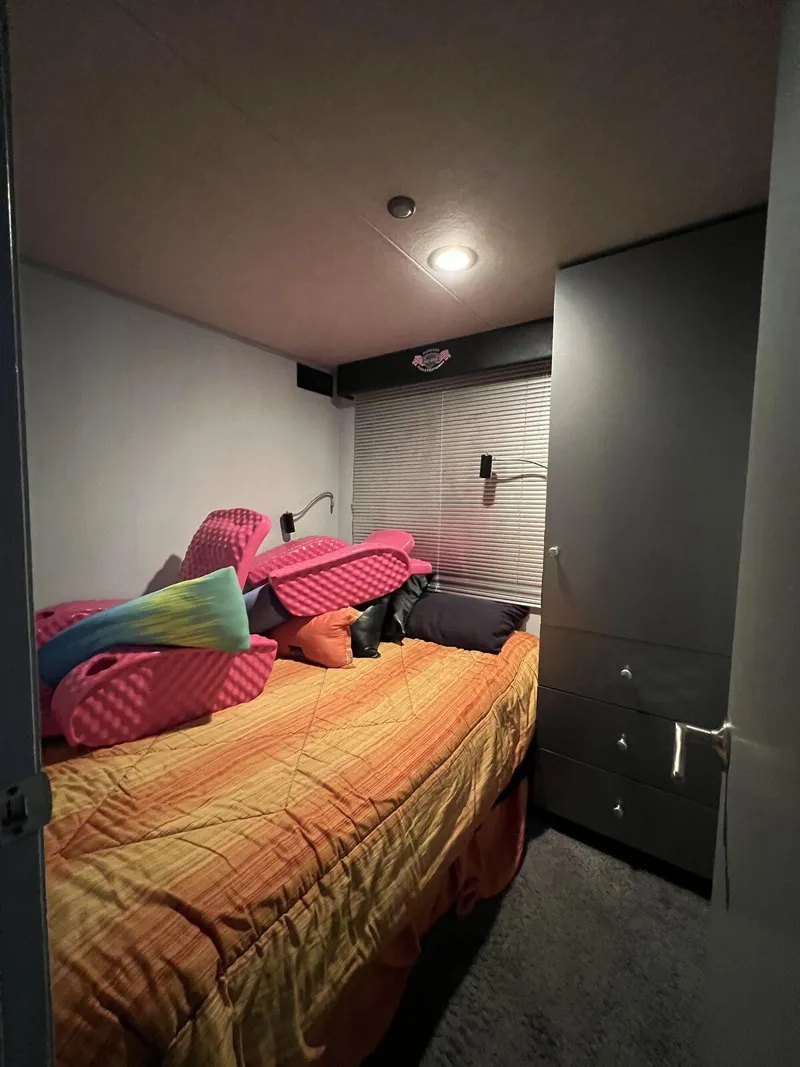 Slide: The Image of Cozy bedroom in 1996 Skipperliner 61x16 houseboat with colorful bedding and modern lighting. - 15