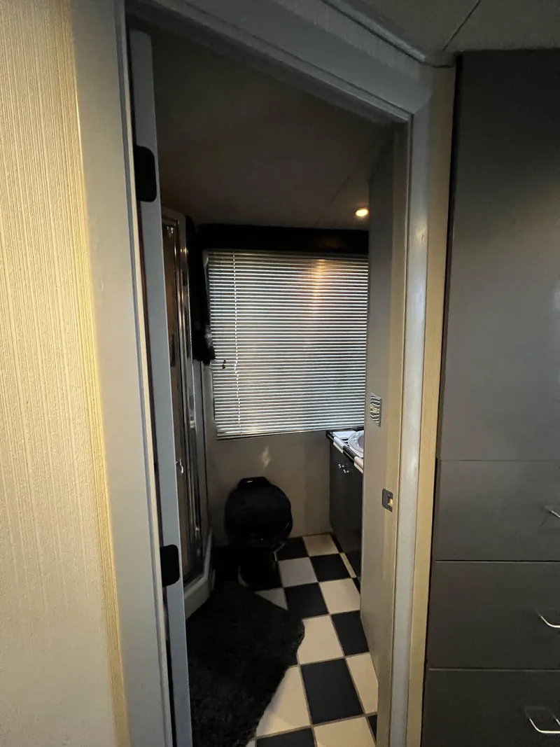 Slide: The Image of Interior of 1996 Skipperliner 61x16 houseboat with checkered floor and window blinds. - 17