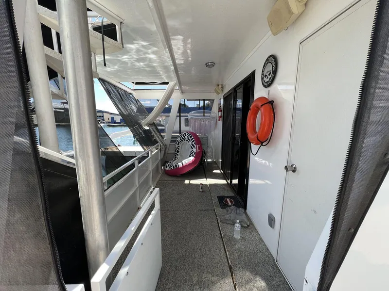Slide: The Image of 1996 Skipperliner 61x16 Houseboat deck with life preserver and inflatable ring. - 19